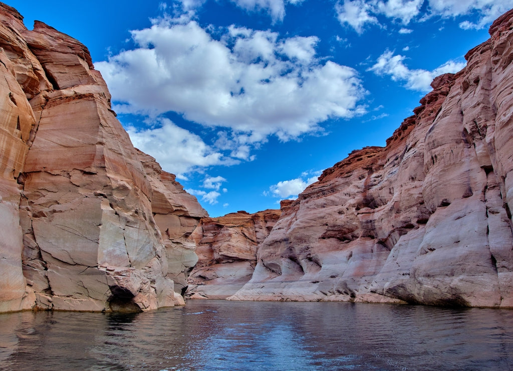 View of narrow, cliff-lined canyon from a boat in Glen Canyon National Recreation Area, Lake Powell, Arizona
