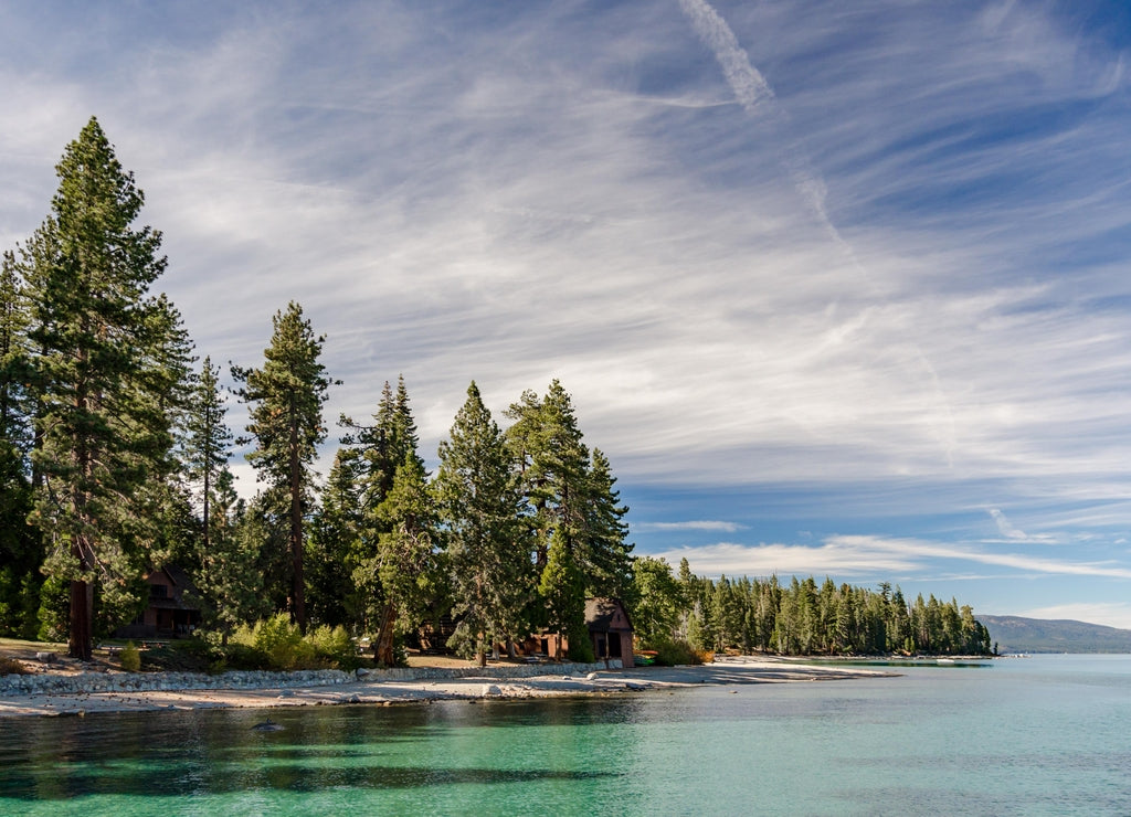 USA, California, El Dorado County, D.L. Bliss State Park. The shoreline and green waters of Lake Tahoe on a day with whispy clouds