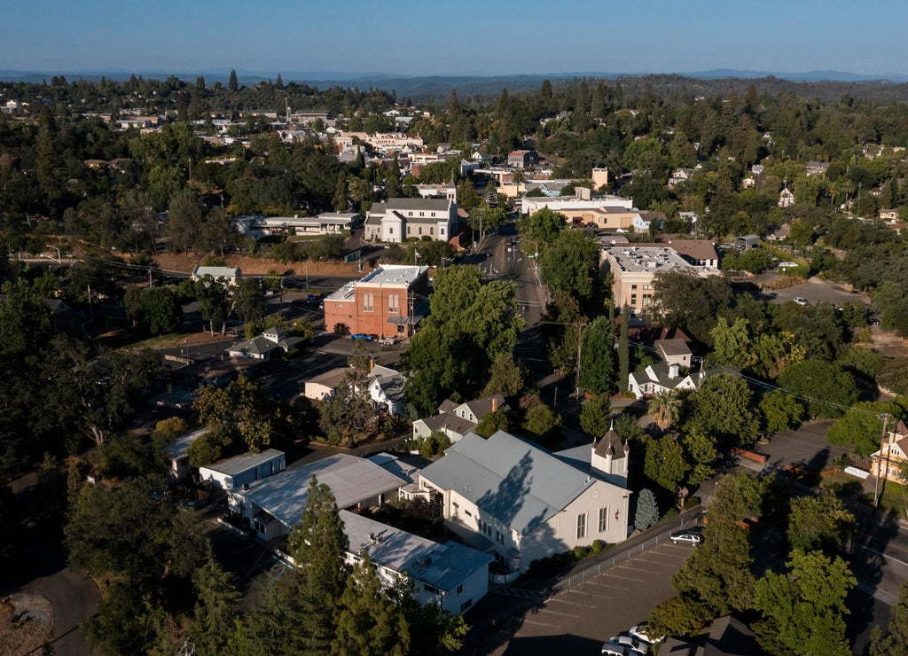 Light shines on historic structures in downtown Auburn, California, USA