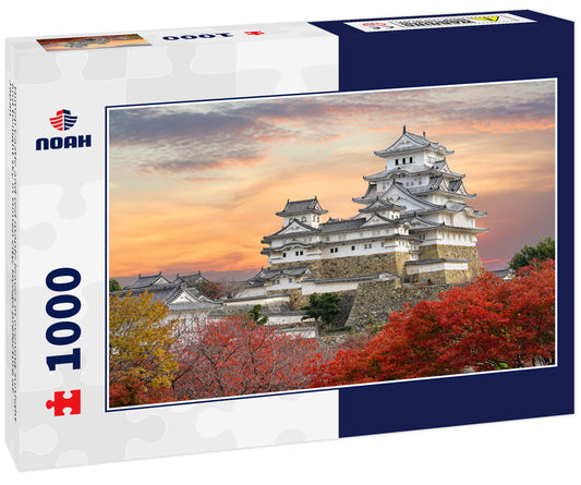 Himeji Castle and red maple leaves in evening sunlight and twilight sky in Himeji city, Hyogo prefecture of Japan
