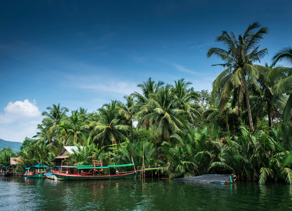 Traditional jungle boat at pier on Tatai river in Cambodia
