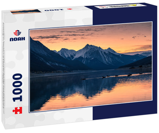 Canadian Rockies with colorful sky and flock of teal floating on Medicine Lake in Jasper national park