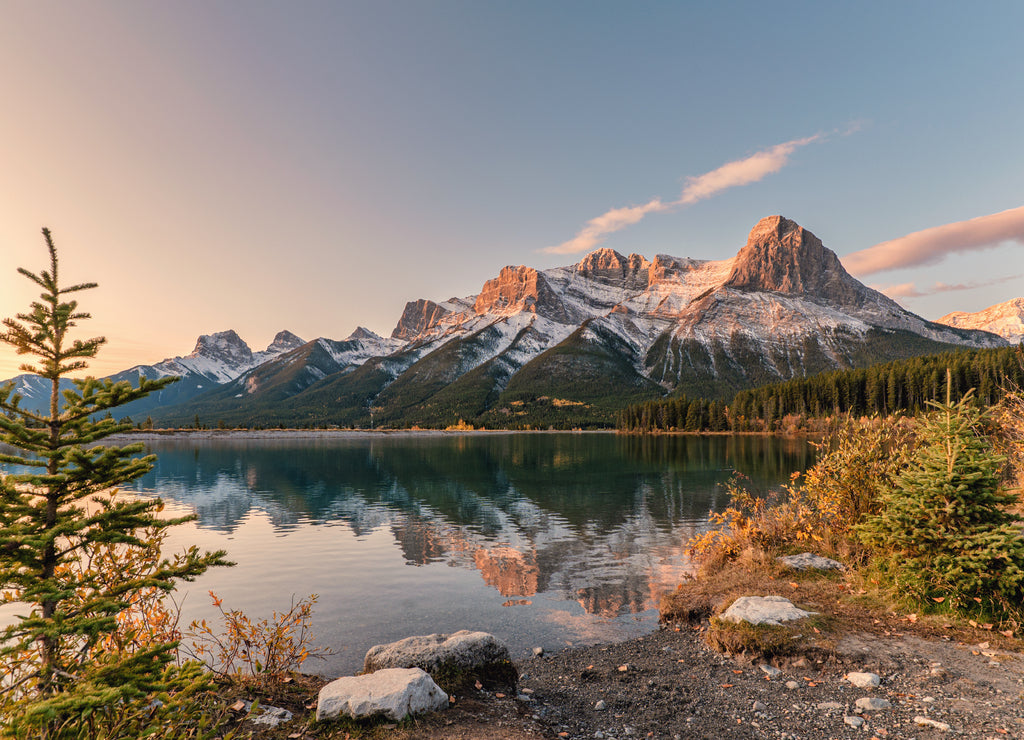 Sunrise on Mount Rundle with colorful sky reflection on Rundle Forebay reservoir in autumn at Canmore