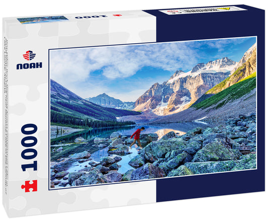 Boy Hiker Rock Hopping Across Consolation Lake in Banff National Park near Moraine Lake in the Vicinity of Lake Louise, Alberta