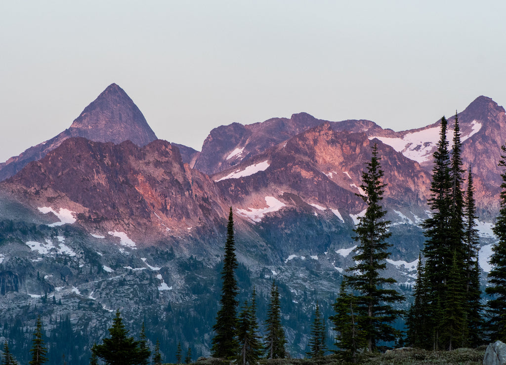 Mountain range at the sunset, rocky mountains, Valhalla Provincial Park, West Kootenays, BC, Canada. Pink an dred undertones, dramatic