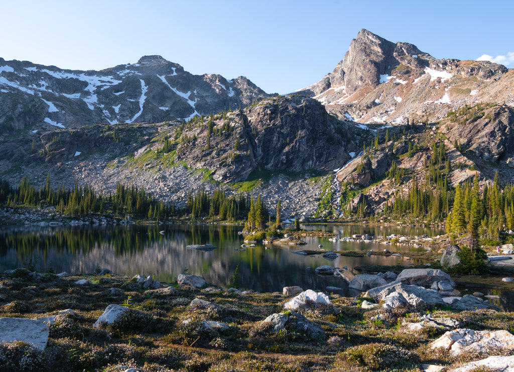 Calm reflection of the mountains in the lake, morning light. Gwillim Lakes, Valhalla provincial park, BC, West Kootenays, Canada
