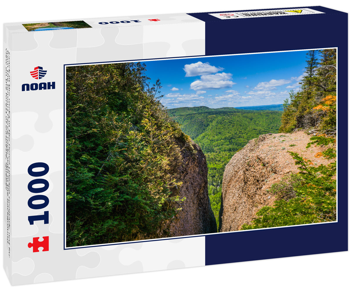 Crack in the rocks in the Percé Unesco Geopark, not far from the famous Percé rock, with in the background view on the forest of Gaspésie, Quebec