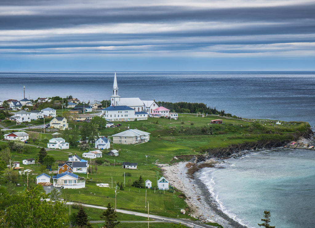 View on the small village of St Maurice de l'Echouerie with its small white church, beach and houses in Gaspesie (Quebec, Canada)