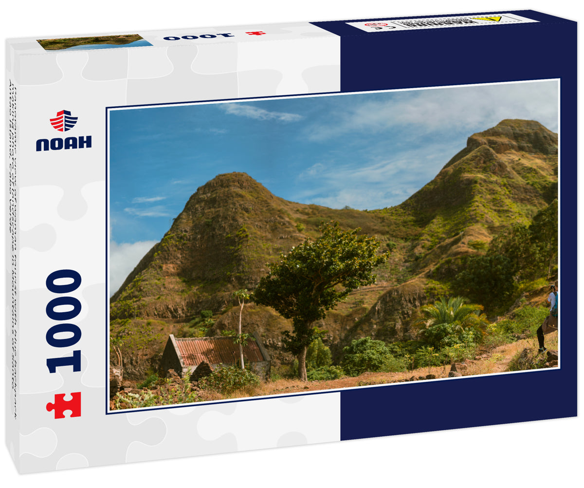 Panoramic view of woman tourist with blue backpack making photo of landscape in Mountains of Santo Antao island, Cabo Verde