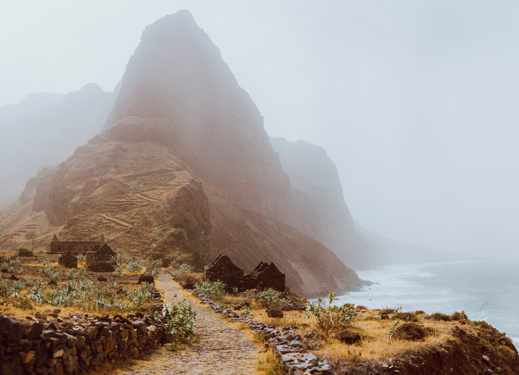 Santo Antao Island, Cape Verde. Panoramic view to Aranhas mountain peak in the valley with house ruins and stony hiking path