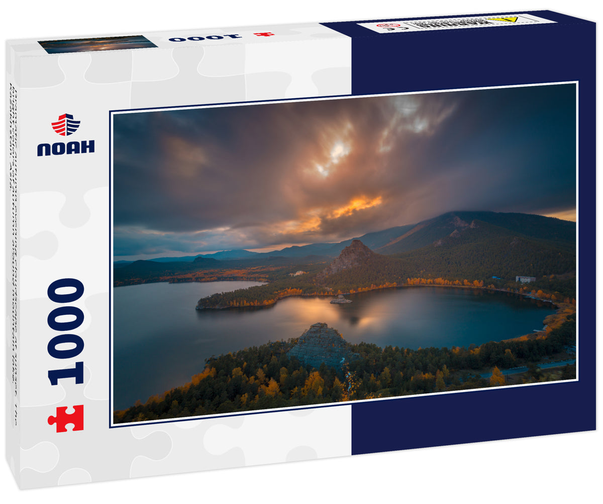 Dramatic autumn evening cloudscape at sunset. The bright colors of autumn around mountain lake. Kazakhstan. Asia.