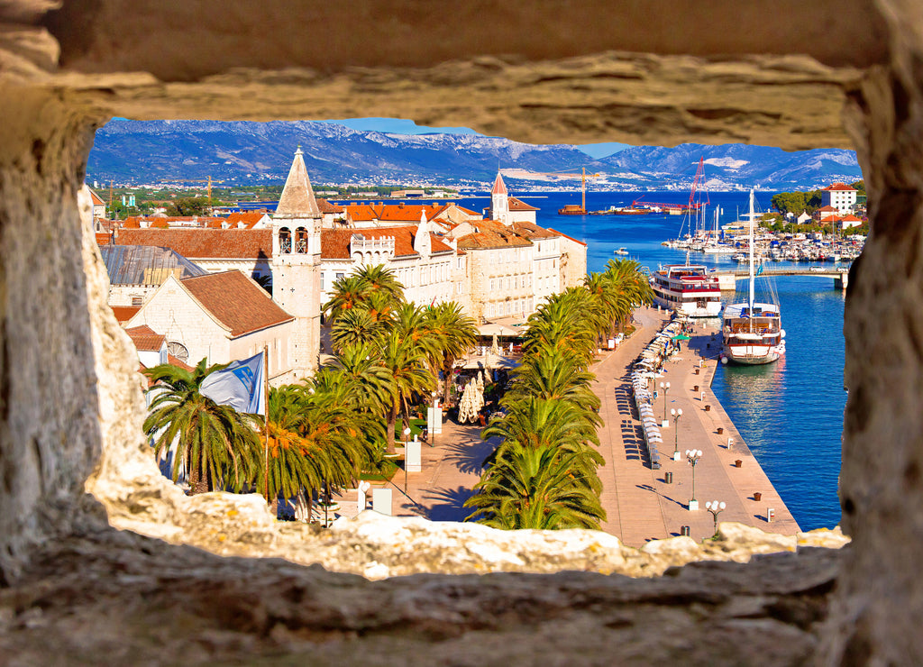 Town of Trogir waterfront and landmarks panoramic view through stone window