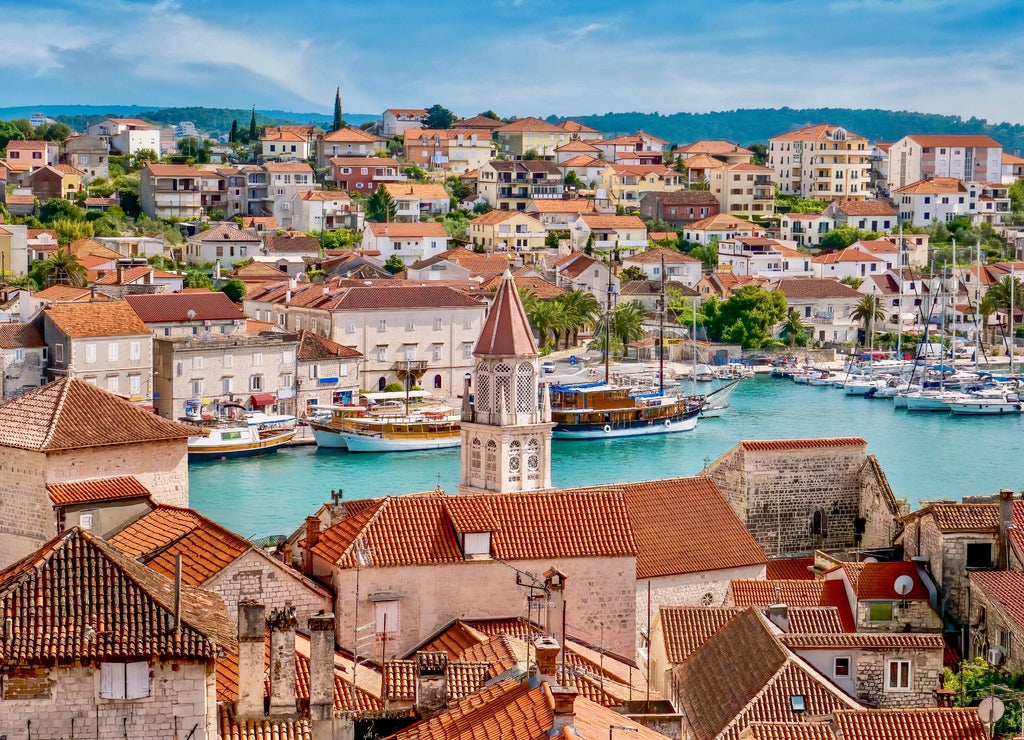 A high angle view of the Old Town of Trogir, Croatia in the foreground, its newer buildings on the mainland. On the central Adriatic coast