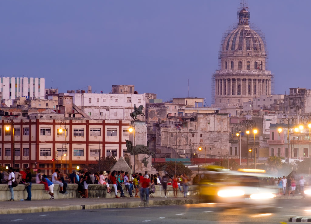 Havana at sunset with traffic trail lights and a view of the Capitol