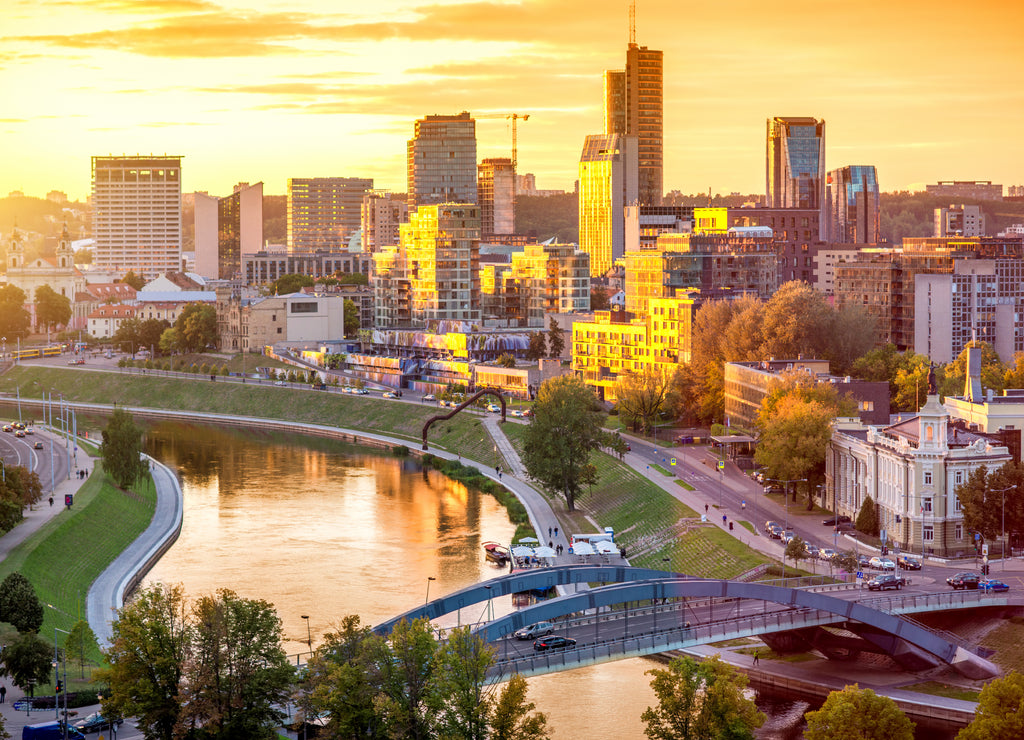 Cityscape view on the financial district with modern buildings, river and bridge during the sunset in Vilnius, Lithuania