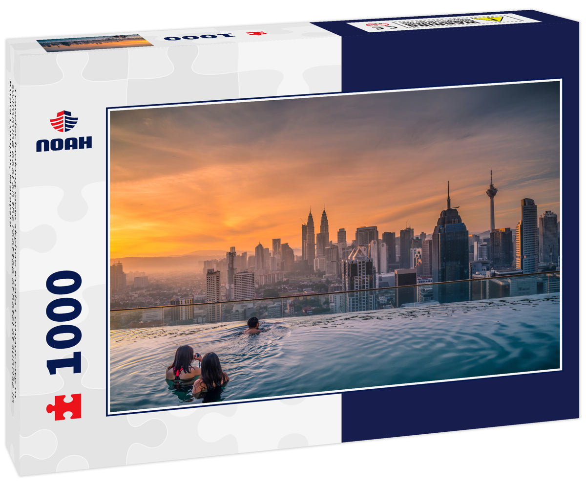 Traveler looking view skyline Kuala Lumpur city in swimming pool on the roof top of hotel at sunrise in Kuala Lumpur, Malaysia