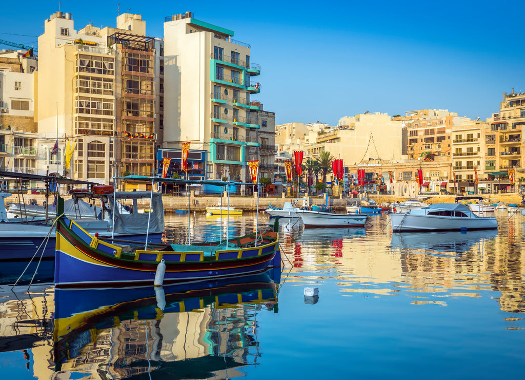 St.Julian's, Malta - Colorful Luzzu fishing boats at Spinola bay at sunrise
