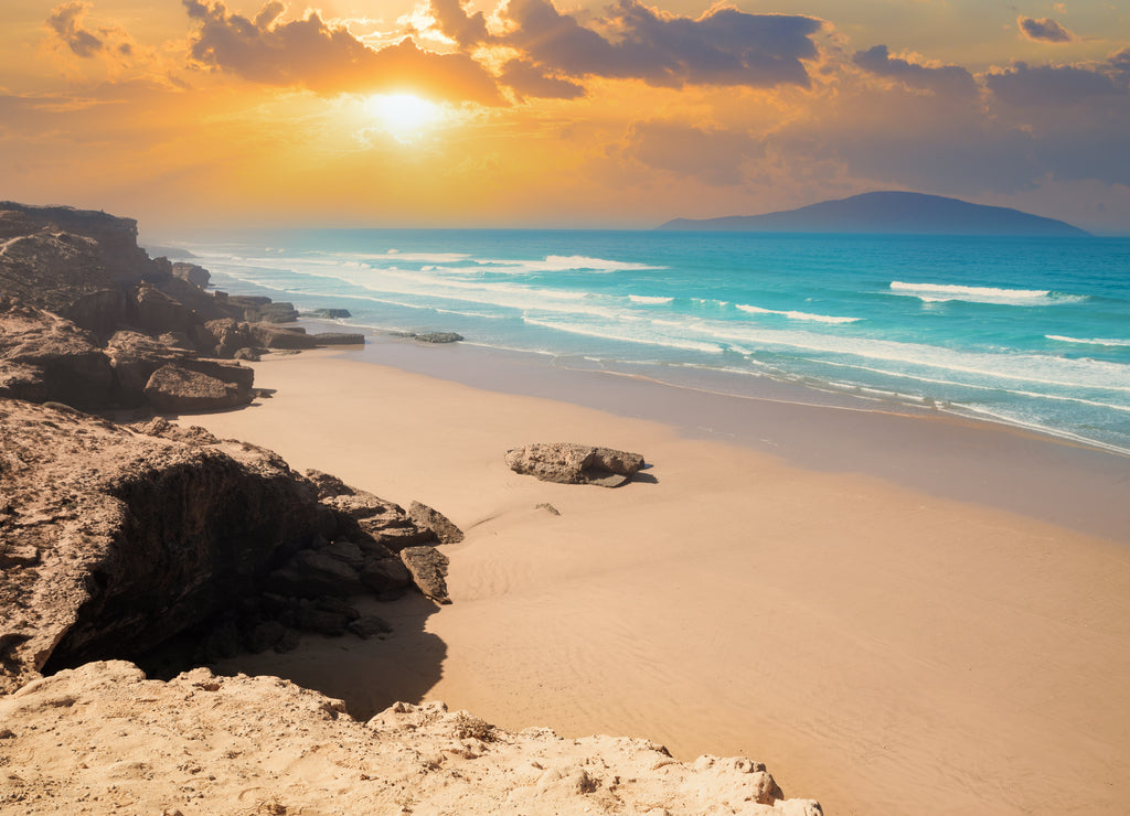 Beautiful sunset illuminating the Agadir beach and sand on the Atlantic ocean coast in Morocco