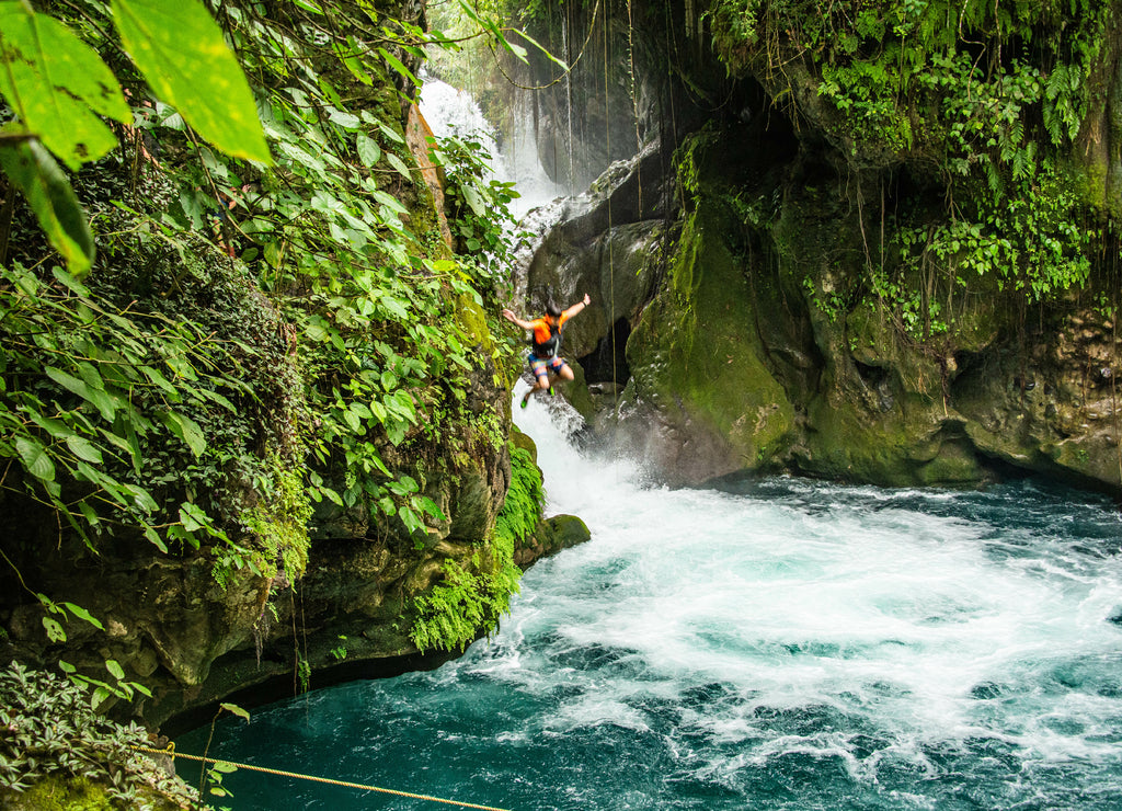 Jumping at the beautiful Puente de Dios waterfall and cenote, Tamasopo, San Luis Potosi, Mexico