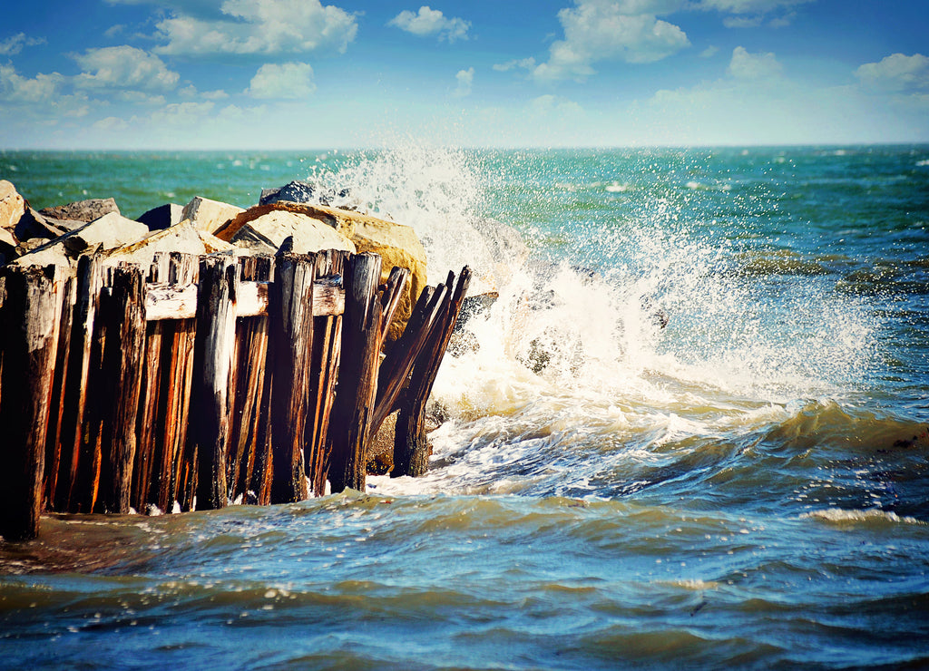 A rushing wave hitting a pier on Sullivan's Island, South Carolina