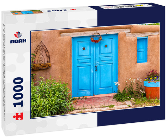 New Mexico traditional colorful architecture with blue turquoise adobe color painted door and ristras decorations at entrance garden