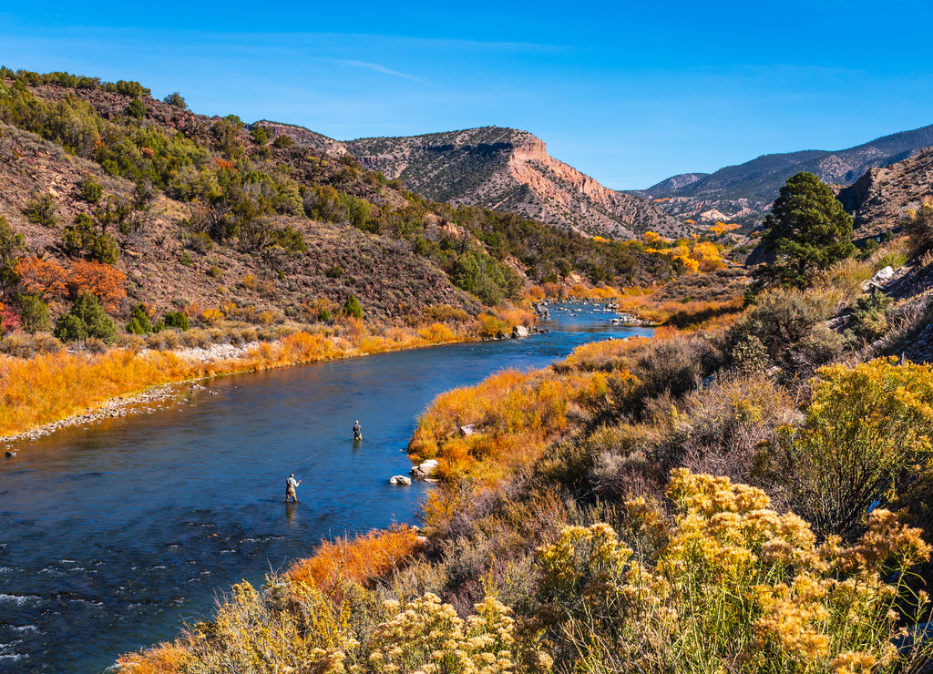 Beautiful autumn colors with fly fishermen on Rio Grande river flowing through New Mexico