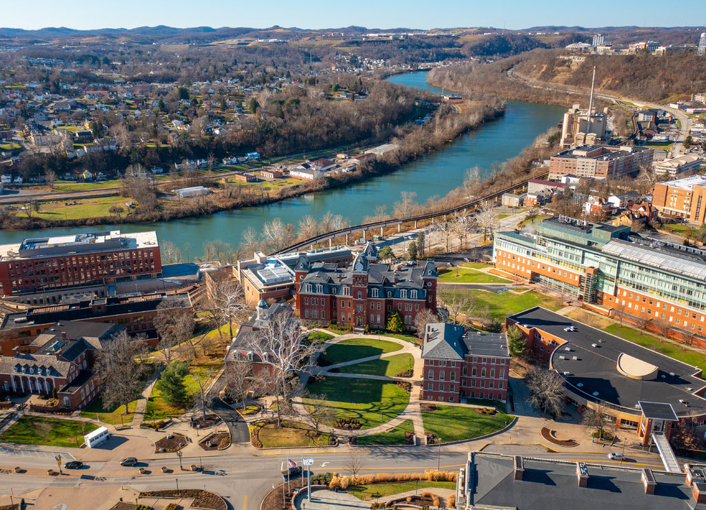 Aerial drone panoramic shot of the downtown campus of WVU in Morgantown West Virginia showing the river in the distance