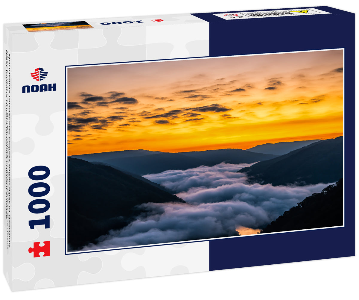 Mountains landscape clouds foggy mist in morning above new river gorge valley in Grandview Overlook, West Virginia during morning colorful sunrise