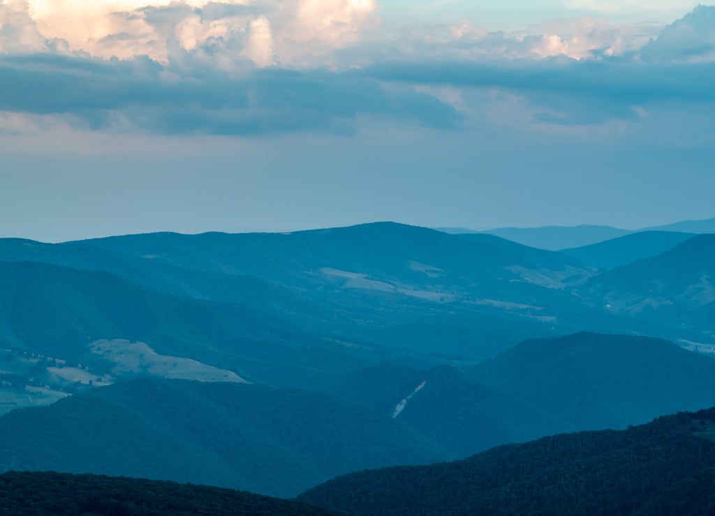 A dramatic sunset viewed from Spruce Knob West Virginia in the Appalachian Mountains looking down on hills in the surrounding valleys