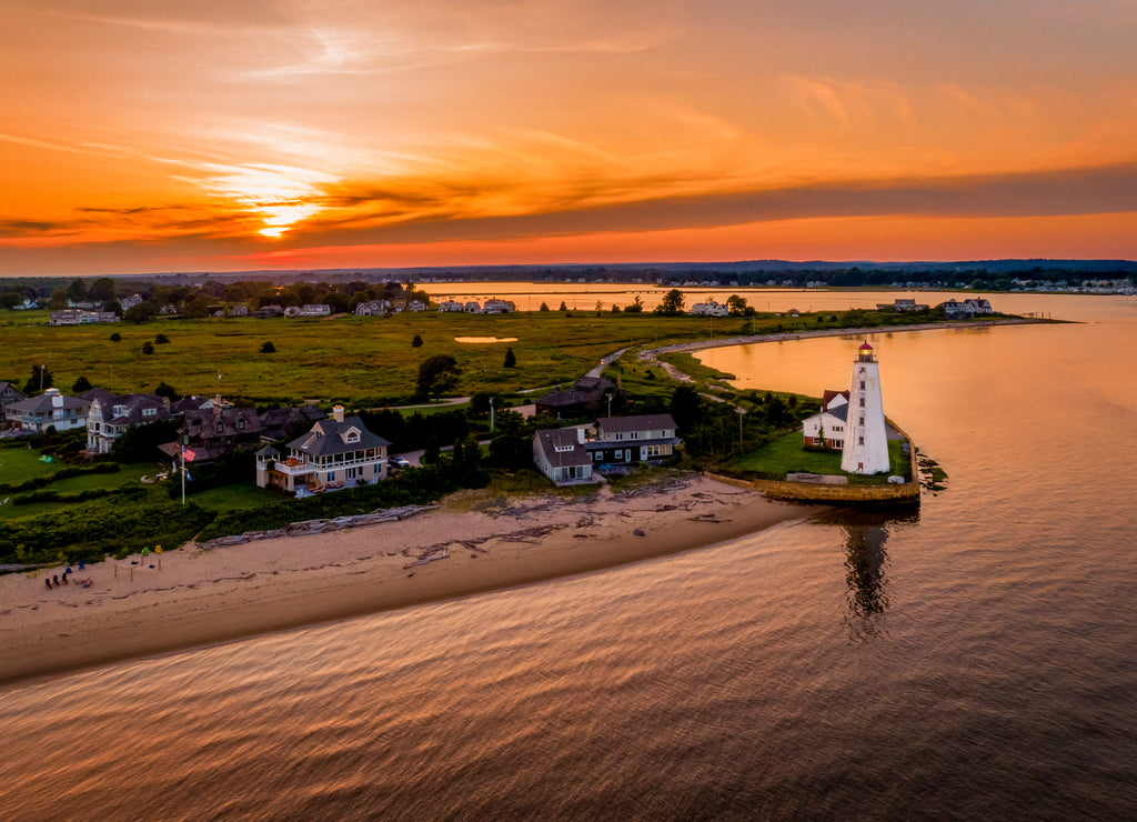 Summer sunset in Old Saybrook along the Connecticut River with Lynde Lighthouse in the foreground and a summer sunset