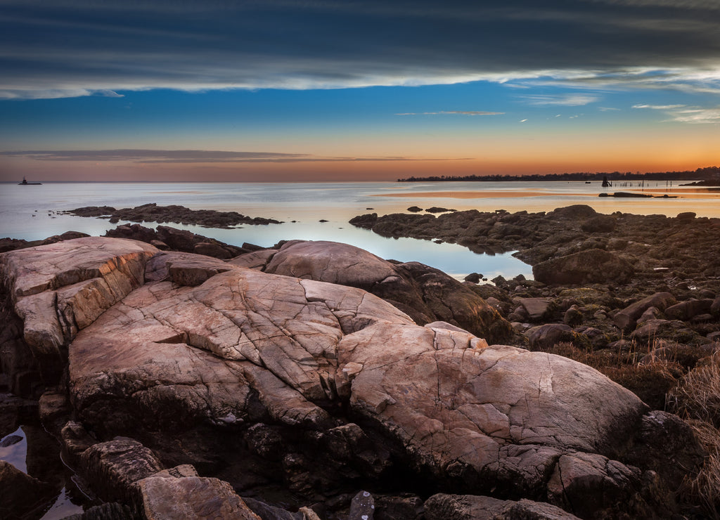 Boulders On The Shore At Sunset With Lighthouse In The Distance, Connecticut