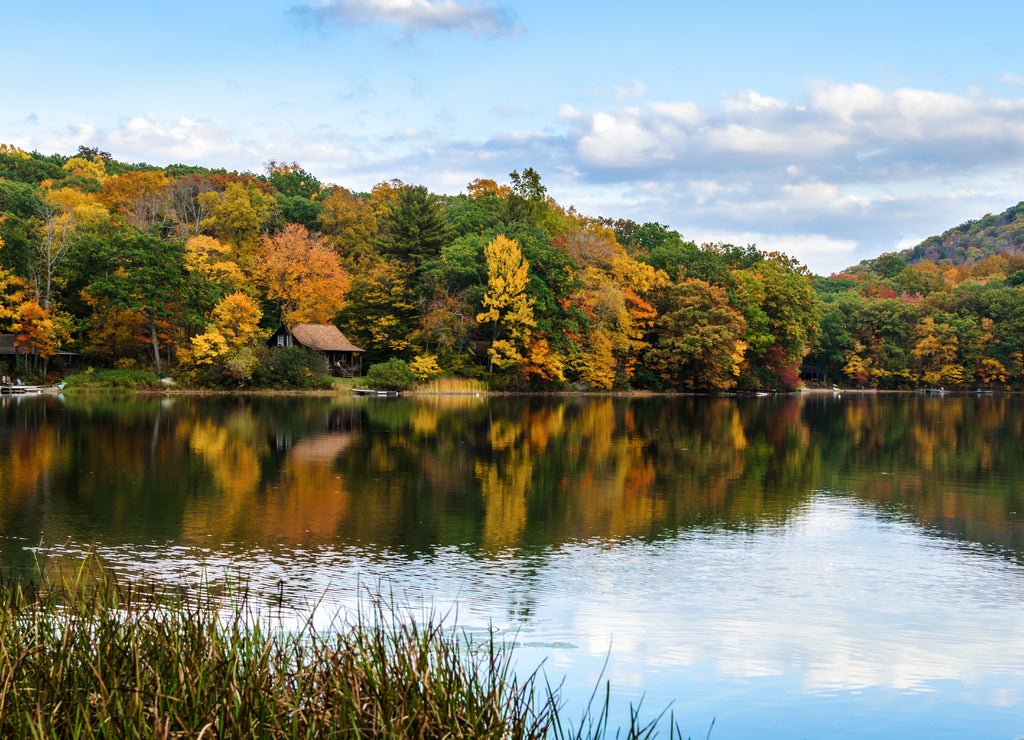 Mountain Lake with Wooded Shore under Blue Sky in Autumn and Reflection in Water, Connecticut
