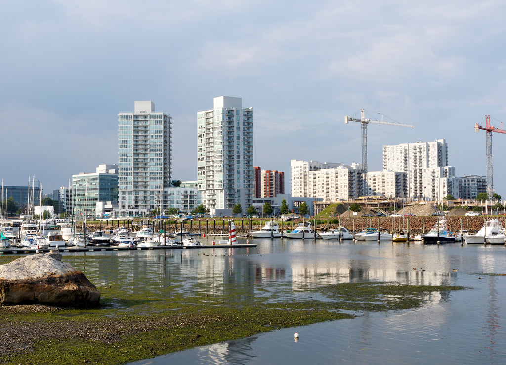 Marina in Stamford, Connecticut, with apartment buildings, boats, water and construction cranes