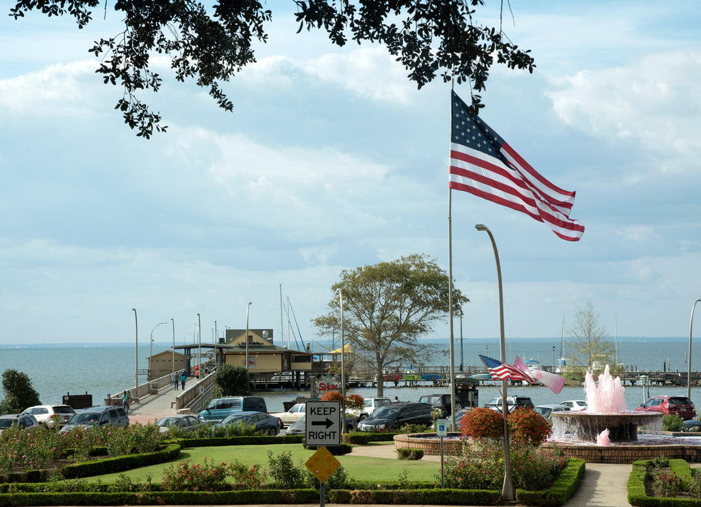 Fairhope Pier on Mobile Bay in Baldwin County Alabama USA. A fountain supporting Cancer Awarenes is spurting pink water