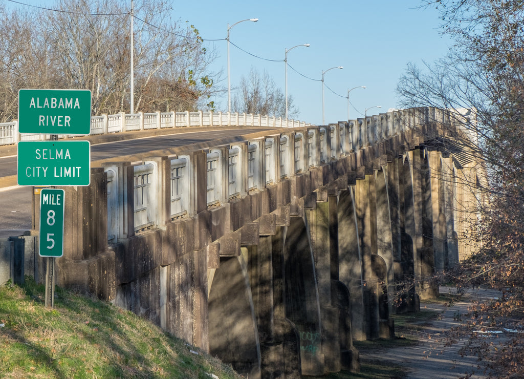 Green highway sign at the Edmund Pettus Bridge for Selma, Alabama