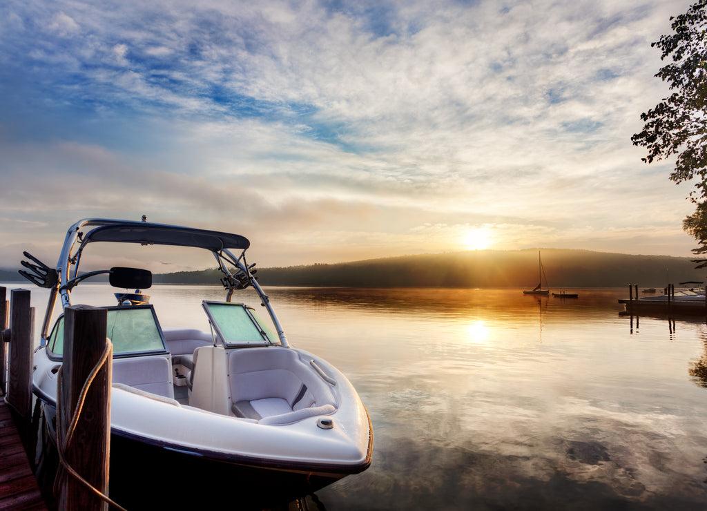 Sun and mist on boat dock at sunrise on a summer day. Merrymeeting Lake, New Hampshire