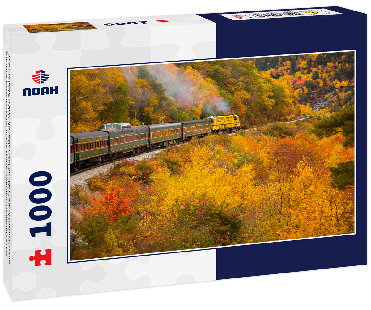 The Conway Scenic Railway train on the Crawford Notch route, just west of Bartlett, New Hampshire. Hardwood trees are showing peak fall color in the White Mountain National Forest