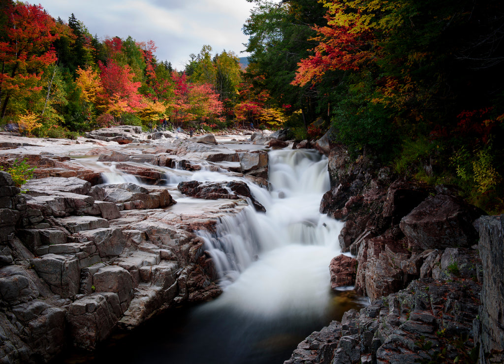Swift river at rocky scenic gorge area during fall season, New Hampshire