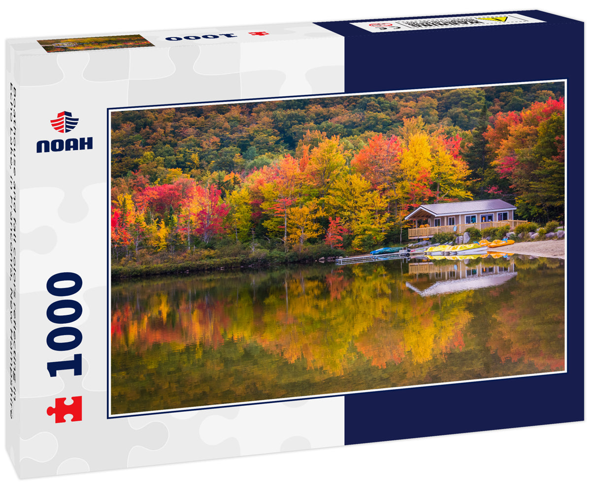 Boathouse and fall colors reflecting in Echo Lake, in Franconia, New Hampshire