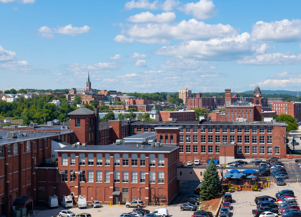 Manchester historic city skyline including Amoskeag Mill buildings and West Side Sainte Marie Parish church in Manchester, New Hampshire, USA