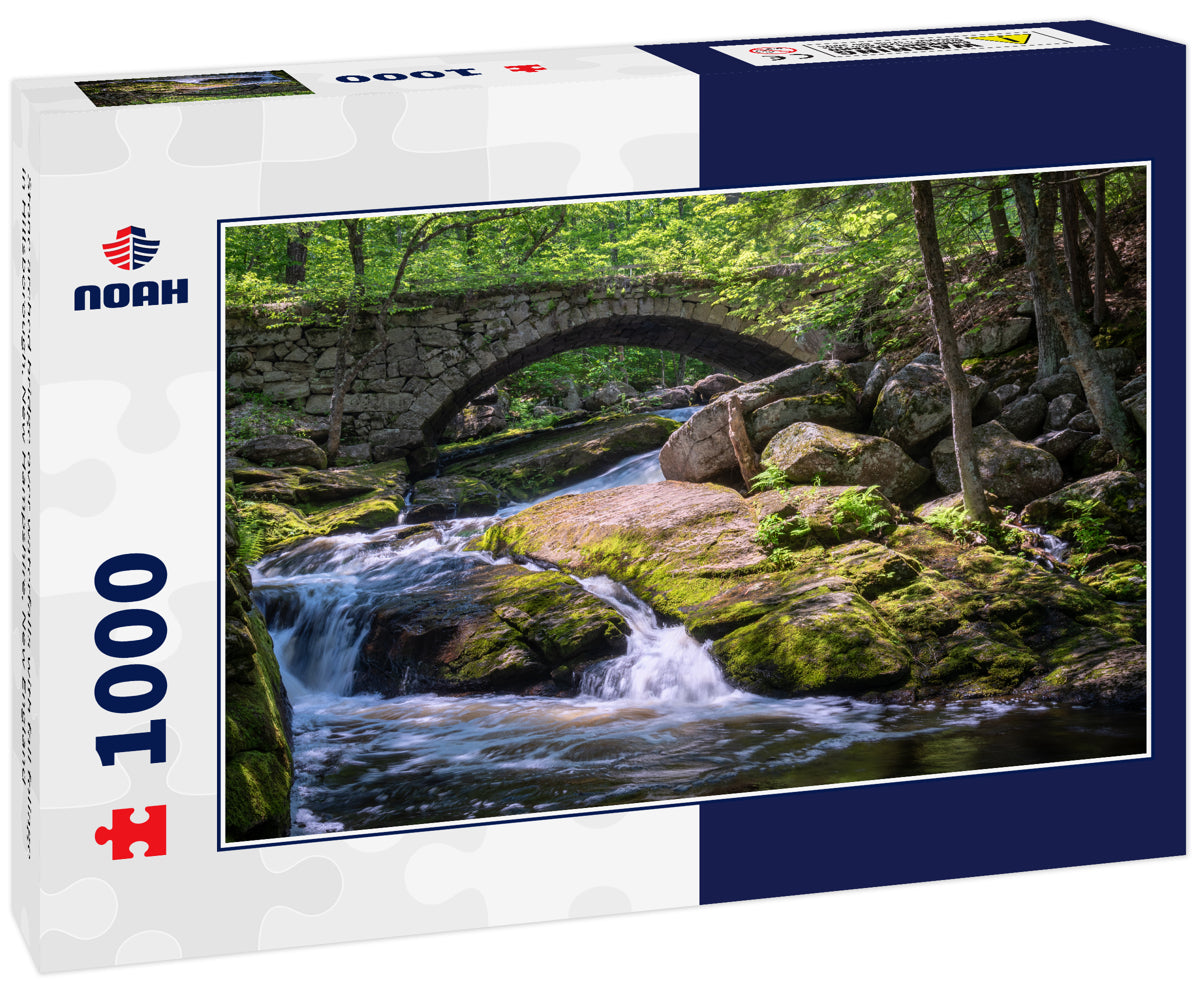Stone arched bridge over waterfalls with fall foliage in Hillsborough, New Hampshire, New England