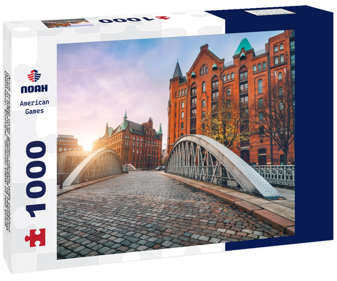 Noah Jigsaw Puzzle Arch bridge over alster canals with cobbled road in historical Speicherstadt of Hamburg, Germany, Europe. Scenic view of red brick building lit by golden sunset light 1000 pieces
