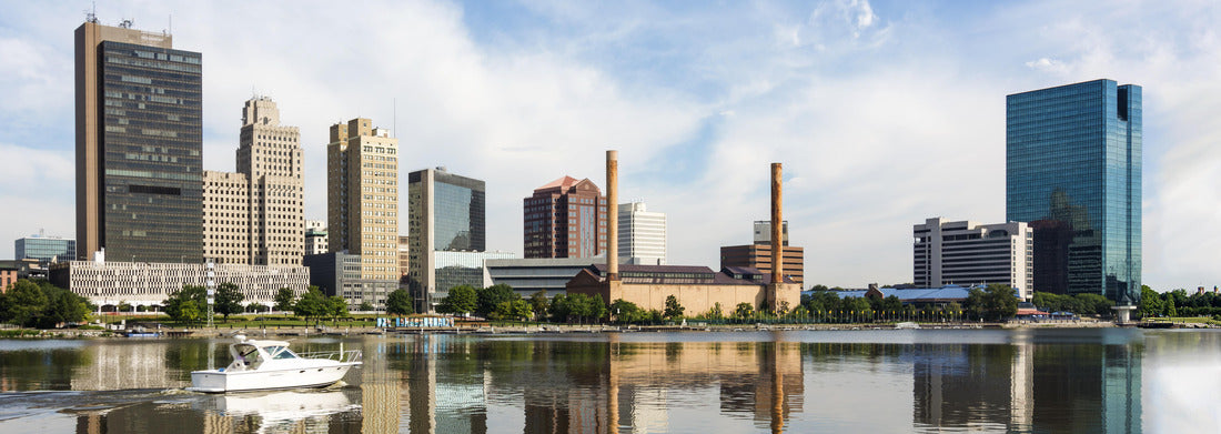 Noah Jigsaw Puzzle A panoramic view of downtown Toledo Ohio's skyline reflecting into the Maumee river with a power boat cruising by. A beautiful blue sky with white clouds for a backdrop panorama 1000 pieces