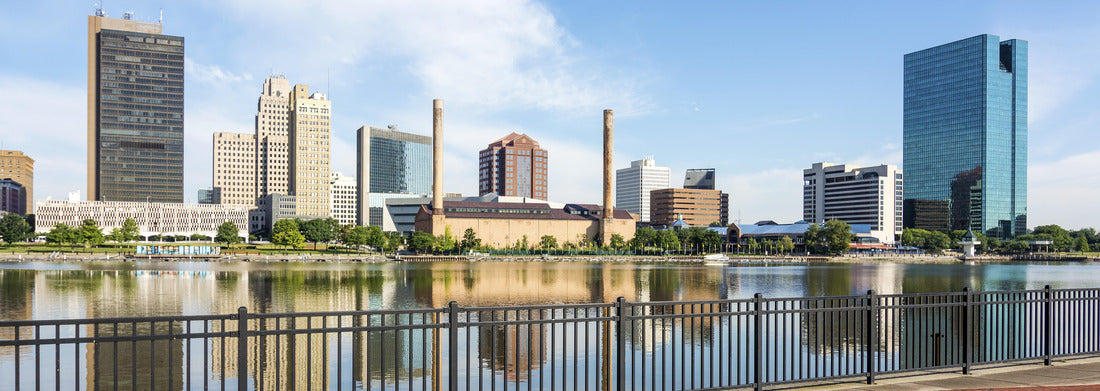 Noah Jigsaw Puzzle A panoramic view of downtown Toledo Ohio's skyline from across the Maumee river at a popular restaurant area with a paver brick boardwalk and a decorative iron railing panorama 1000 pieces