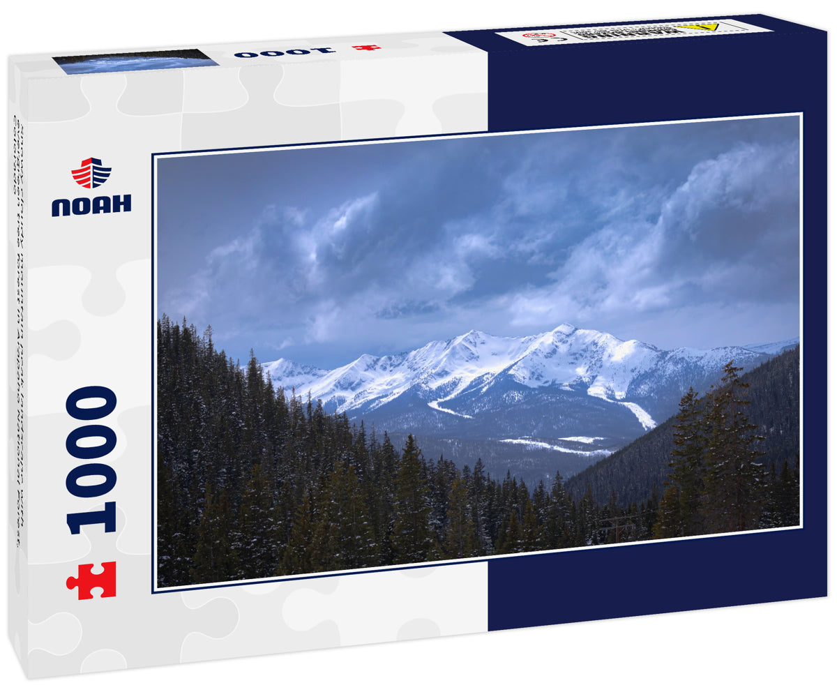 Snowy cloudy mountain peak landscape with evergreen tree forest in Arapaho National Forest, Colorado