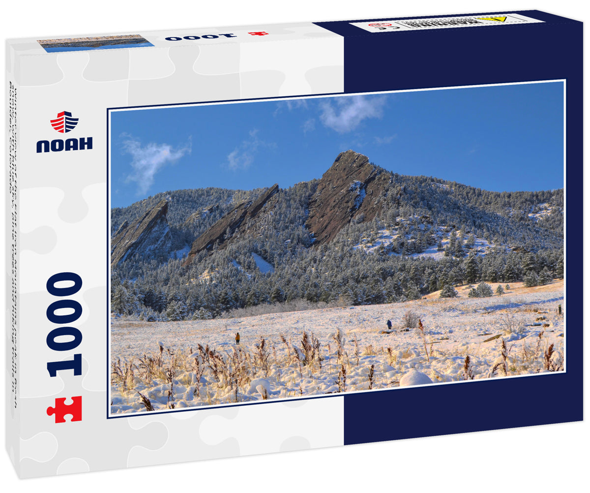 Winter view of the Flat Iron Mountains peak in fresh snow, with blue sky, pine trees and hiking trails in Boulder, Colorado