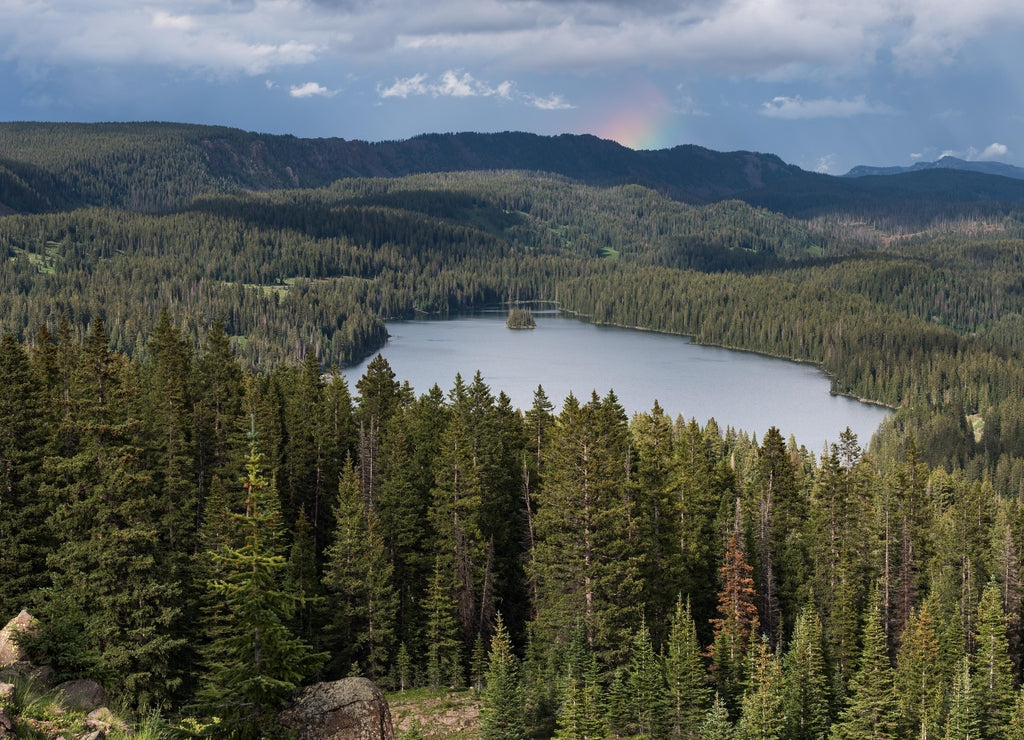 View Point on Grand Mesa National Forest Colorado has over 300 lakes. Partial Rainbow above Island Lake, which is one of the more popular destinations on the Grand Mesa