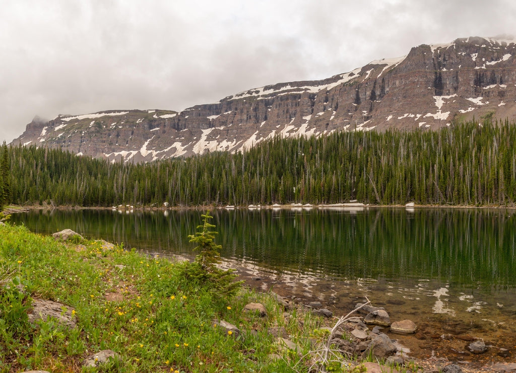 Deep Lake reflects the Chinese Wall in the Flat Tops Wilderness, Colorado, USA