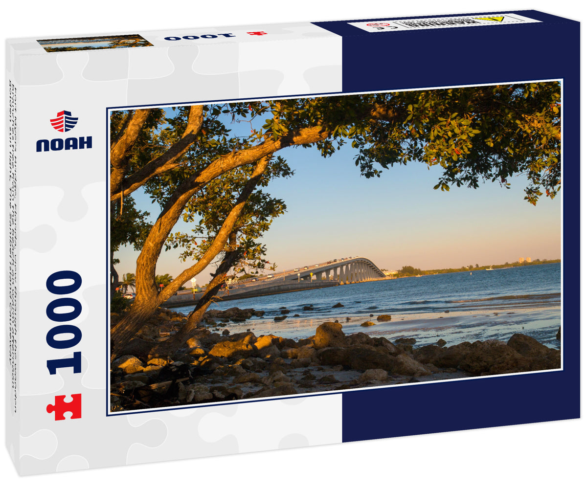 Fort Myers Bridge, Florida, view through the wooden branches tree from the beach on warm afternoon golden sun light, The Sanibel Island Causeway