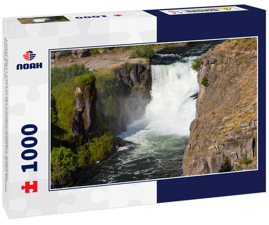 Lower Mesa Falls in the Caribou-targhee National Forest with mist being splashed onto the green foliage and rock tower